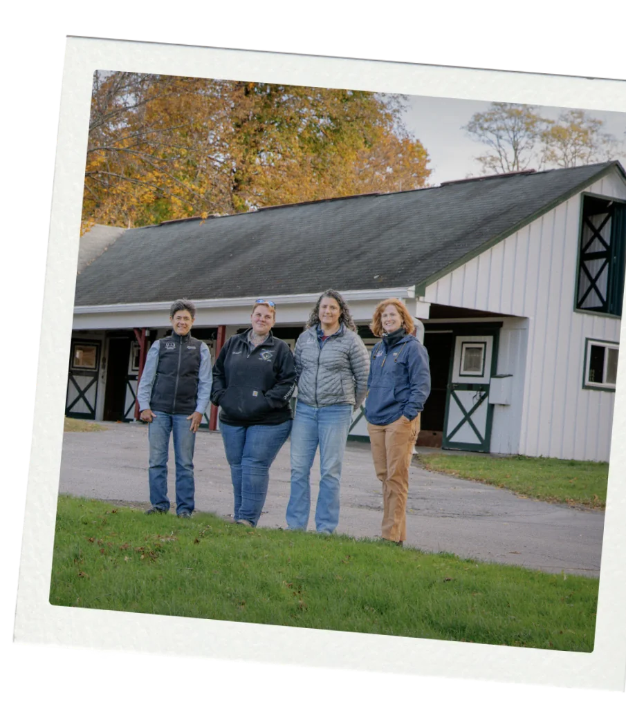 Four members of the Allied Equine team in front of the white barn